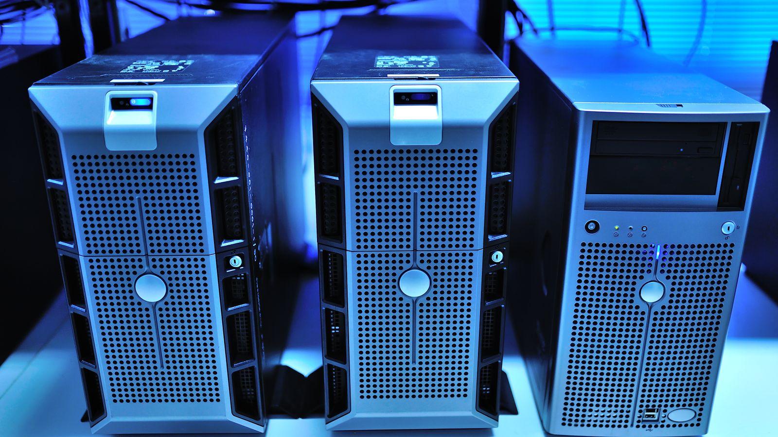 A bare metal server with its lid open, cables visible, no SSDs in the drive bays.
